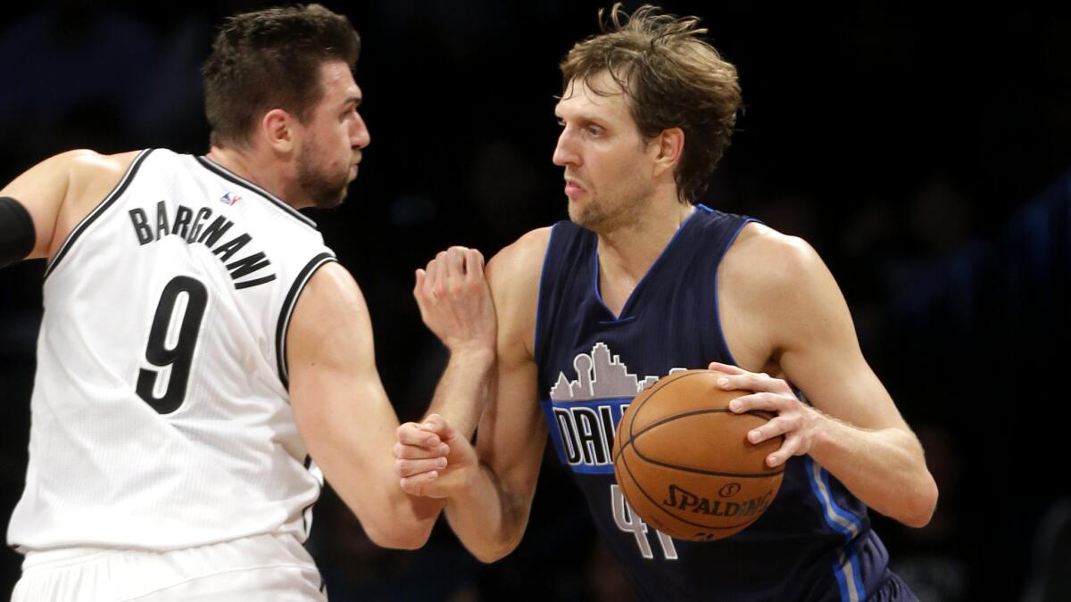 Mavericks forward Dirk Nowitzki drives past Nets center Andrea Bargnani in the second half Wednesday night in Brooklyn.