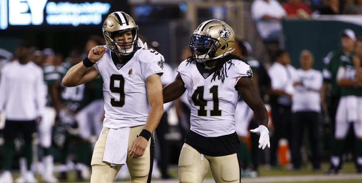 Saints quarterback Drew Brees, left, and running back Alvin Kamara celebrate a touchdown on 