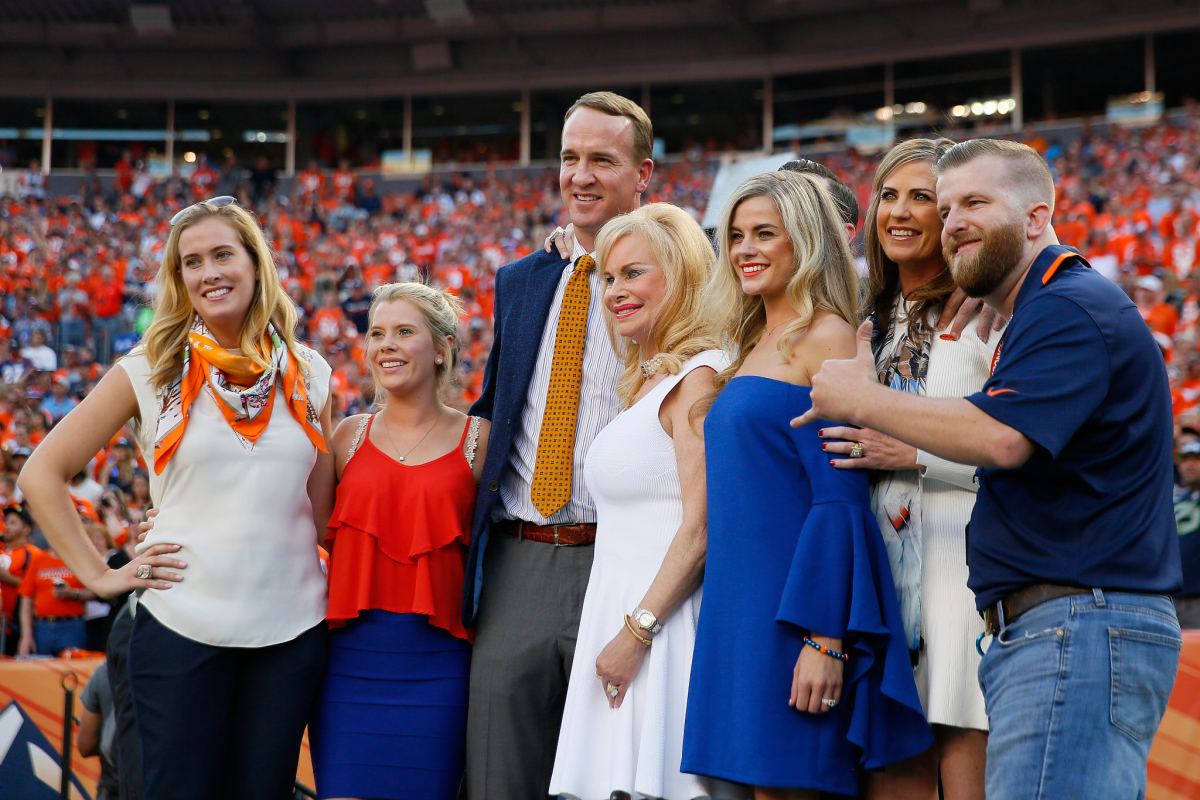Peyton Manning poses with Annabel Bowlen and other members of the Bowlen family before a game.