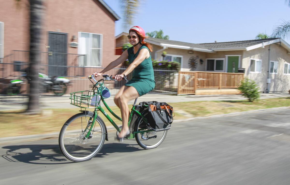 Nicole Capretz, founder and executive director of Climate Action Campaign, rides her electric bike to work on October 10, 2019 in San Diego, California.
