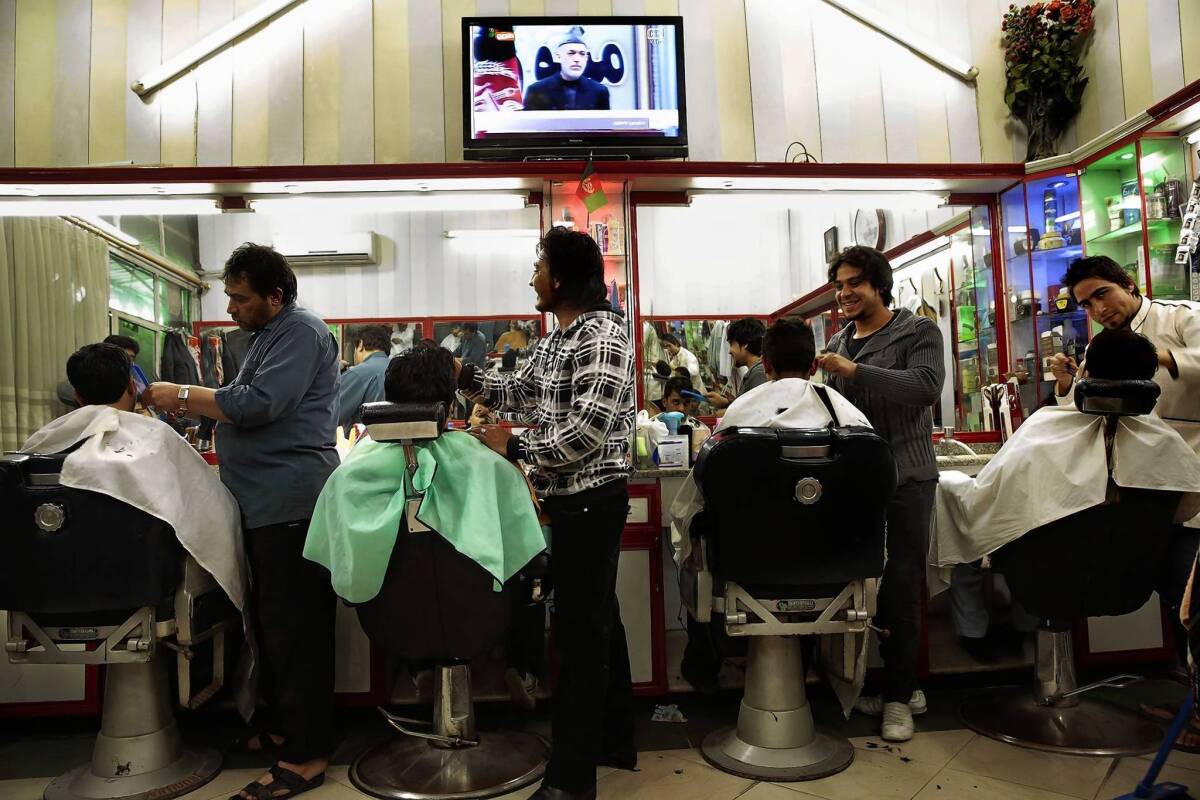 A barbershop in Kabul carries the speech by Afghan President Hamid Karzai. His comments left the U.S. wondering whether he was grandstanding or angling for more concessions in the nations' security agreement.