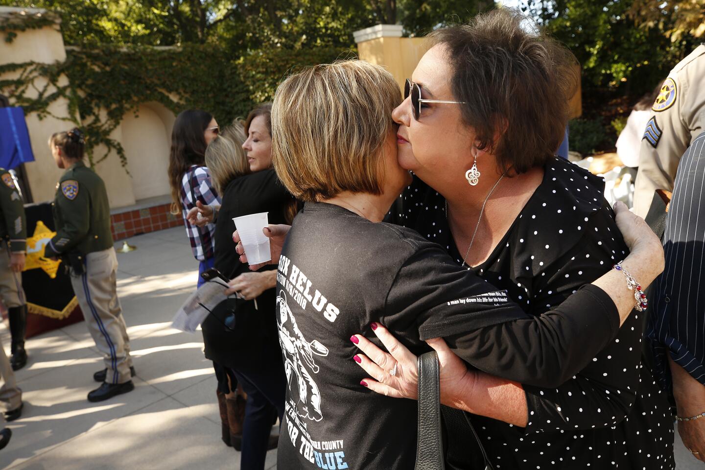 Karen Helus hugs grandmother of a victim