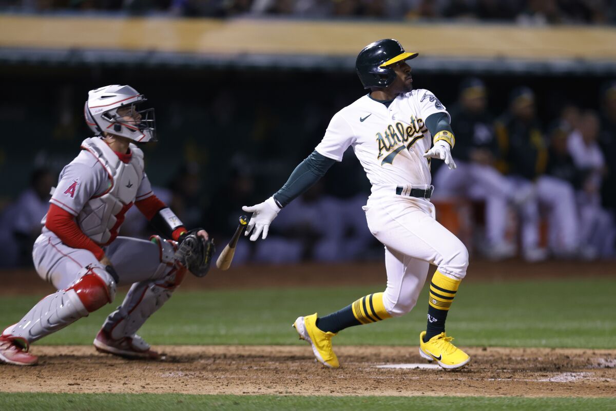 Tony Kemp of the Oakland Athletics watches his RBI double in front of angel catcher Logan O'Hopp.