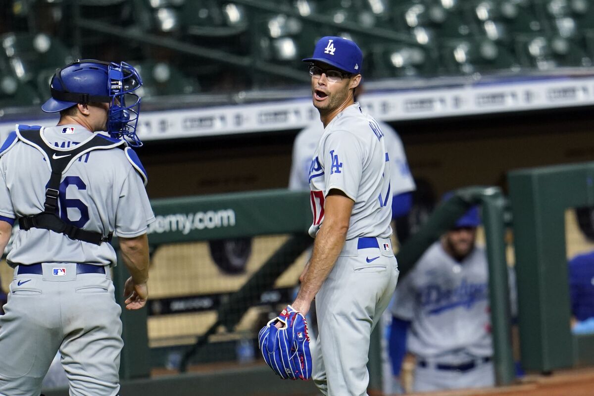 Los Angeles Dodgers relief pitcher Joe Kelly (17) gestures toward Houston Astros' Carlos Correa.