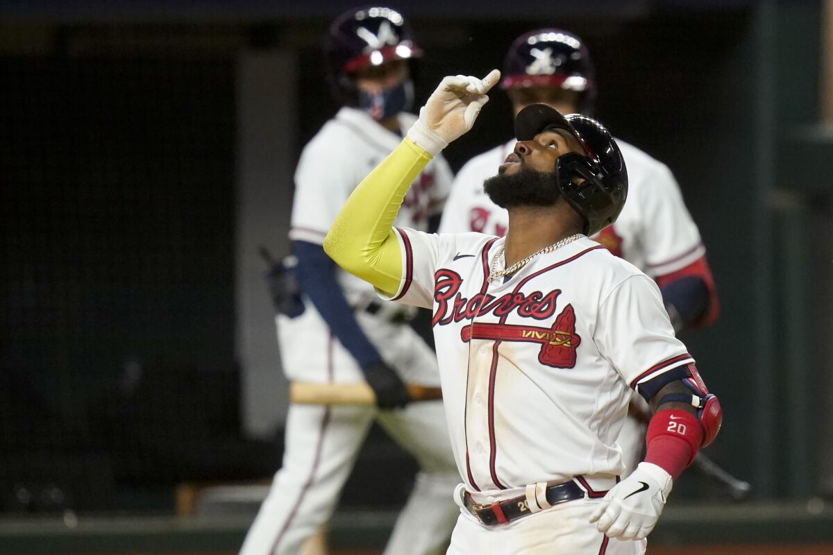 Atlanta's Marcell Ozuna celebrates a home run against the Dodgers during the seventh inning.