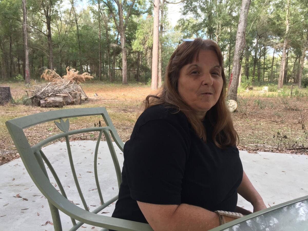 Kathy Watson sits outside her home in Lake City, Fla. The former business owner, who relies on the Affordable Care Act for health coverage, voted for Trump believing he wouldn't really repeal the healthcare law.
