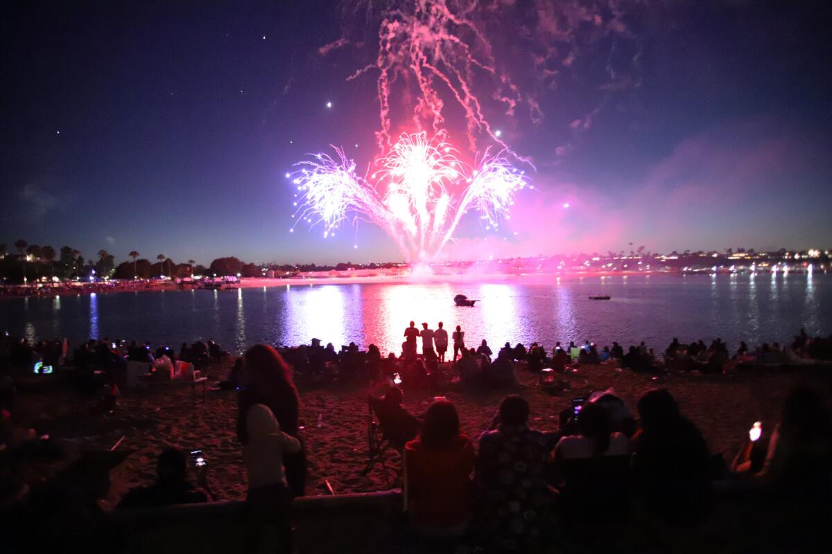 Guests watch the firework show during Independence Day.