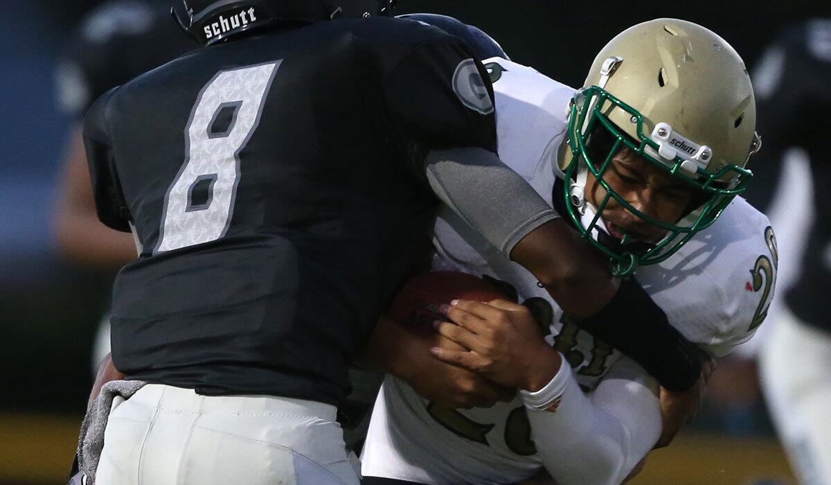 Long Beach Poly's Michael Mauai rushes against Narbonne on Sept. 3, 2015.