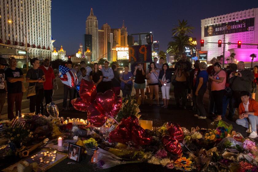 LAS VEGAS, NV - OCTOBER 4, 2017: A crowd gathers Wednesday night to pay tribute at a memorial for the victims of the mass shooting near the crime scene off Las Vegas Boulevard on October 4, 2017 in Las Vegas, Nevada. (Gina Ferazzi / Los Angeles Times)