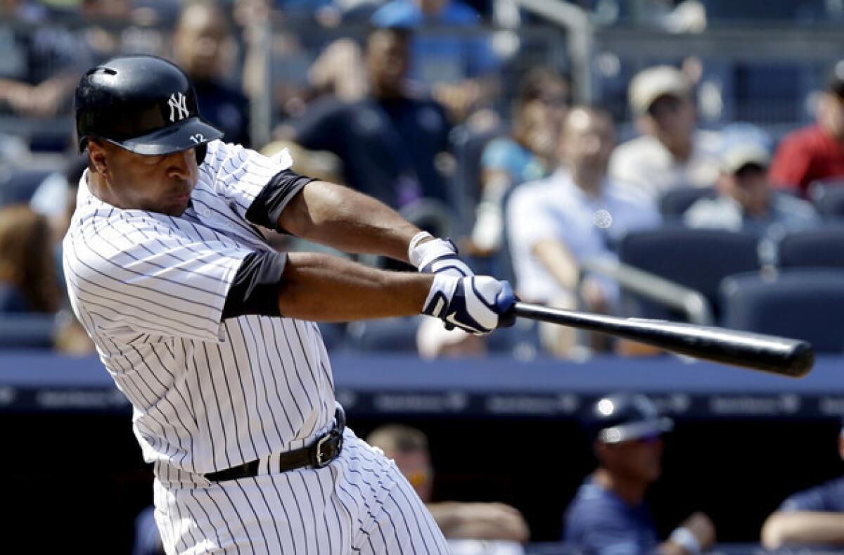 New York Yankees' Vernon Wells hits a ground-rule double to drive in three runs during the seventh inning against the Tampa Bay Rays.