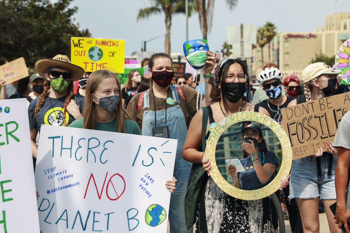 Demonstrators march in downtown San Diego for Friday's climate change rally.