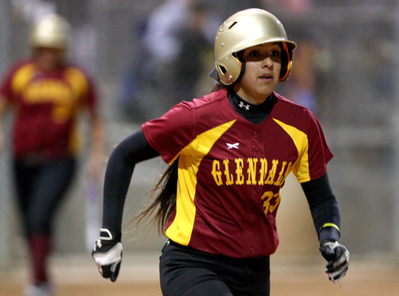 Glendale Community College softball player #33 Bryanna Brito makes it to first base on four balls in a game vs. Santiago Canyon College during the Dave "Hawk" Wilder 11th Annual Softball Tournament 2016 at Glendale Sports Complex in Glendale, on Saturday, Jan. 30, 2016.