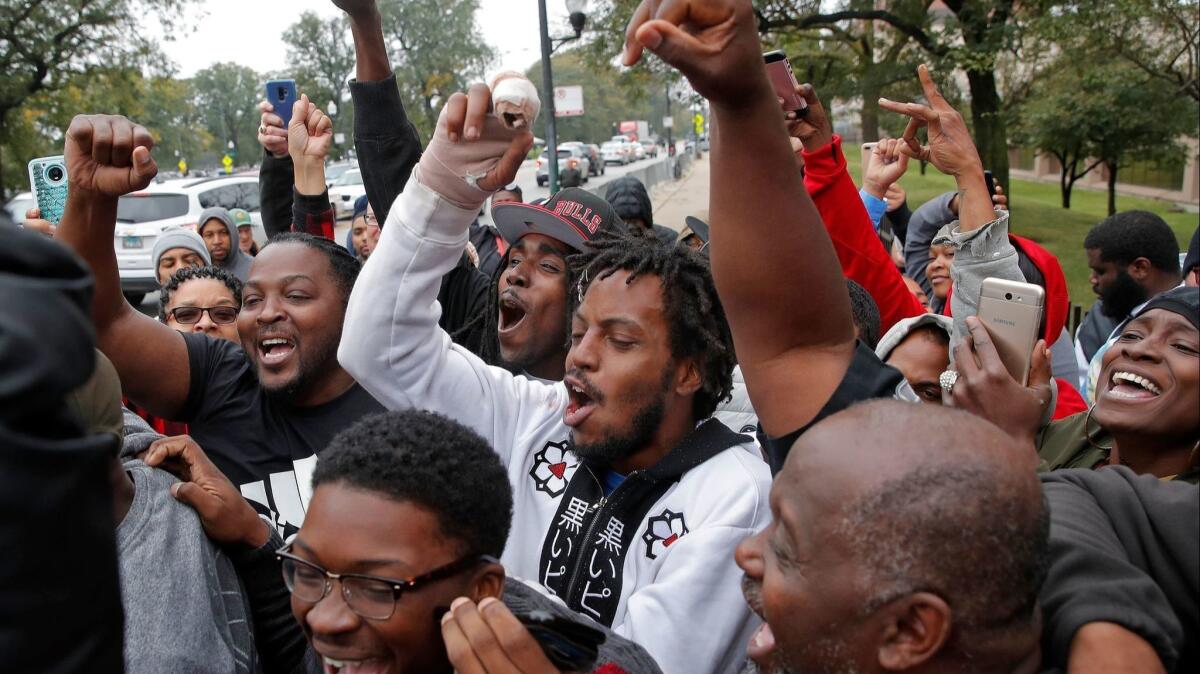 People celebrate the guilty verdict of Chicago Police Officer Jason Van Dyke outside court.