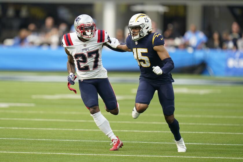 Patriots cornerback J.C. Jackson (27) defends Chargers receiver Jalen Guyton (15) in 2021.