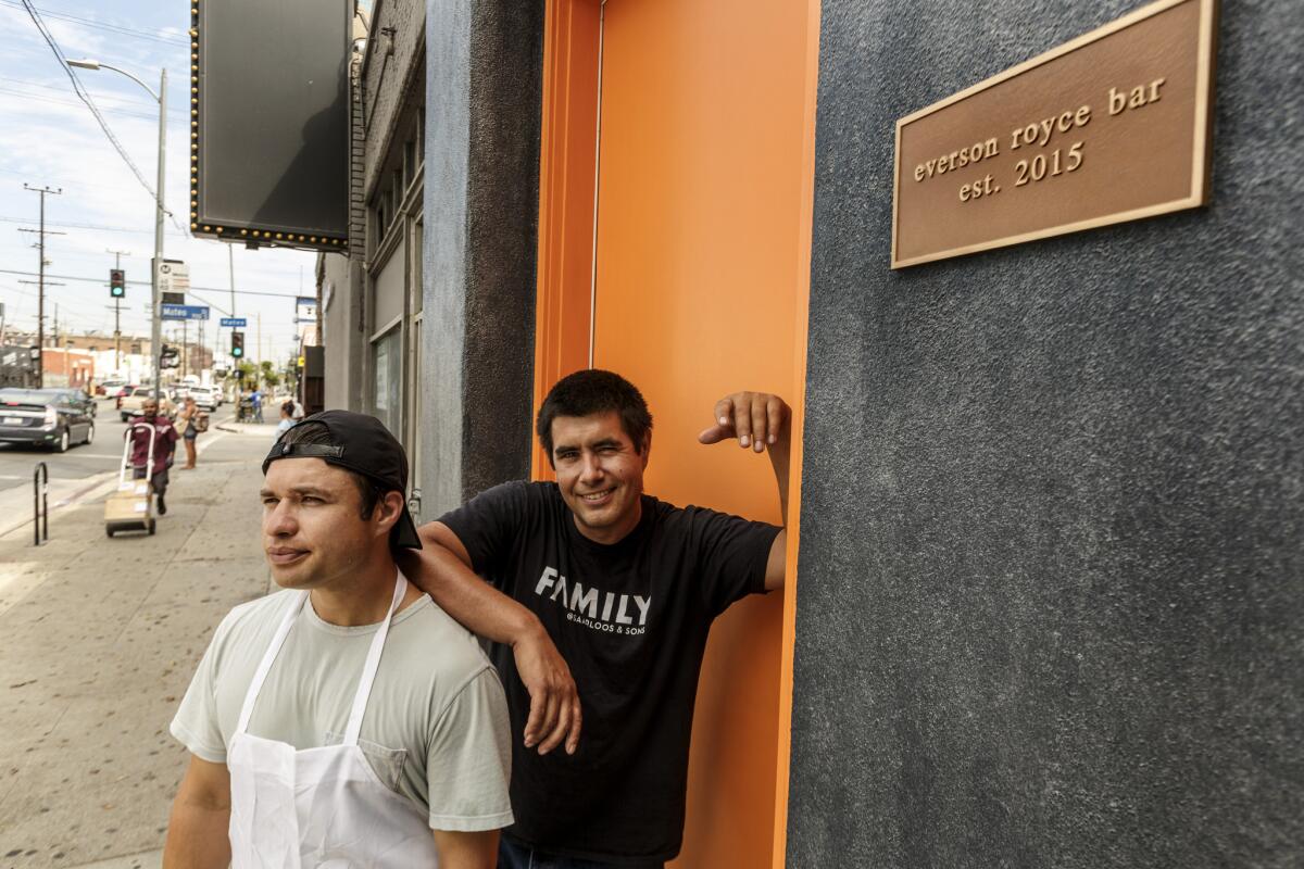 Co-owner Randy Clement, right, poses with chef Matt Molina at the entrance of Everson Royce Bar in the downtown Arts District.