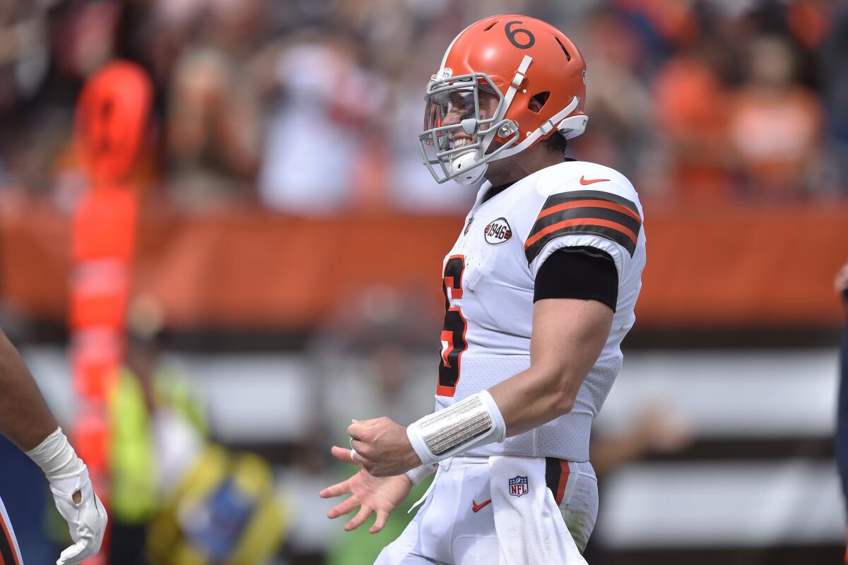 Cleveland Browns quarterback Baker Mayfield (6) celebrates a 13-yard touchdown pass to tight end Austin Hooper during the first half of an NFL football game against the Chicago Bears, Sunday, Sept. 26, 2021, in Cleveland. (AP Photo/David Richard)