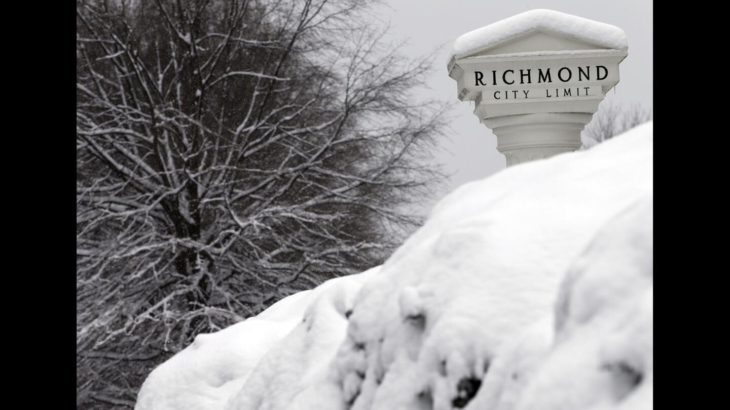 Snow covers bushes and tree limbs on the Richmond city line in Virginia on Feb. 26. Forecasters say 2 to 4 inches of snow may accumulate in the Washington area and its suburbs in Maryland and Virginia.