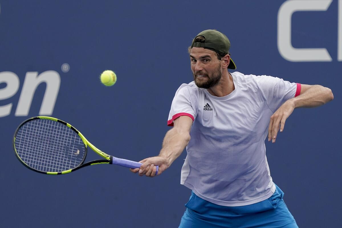 Maxime Cressy returns a shot to Pablo Carreno Busta.