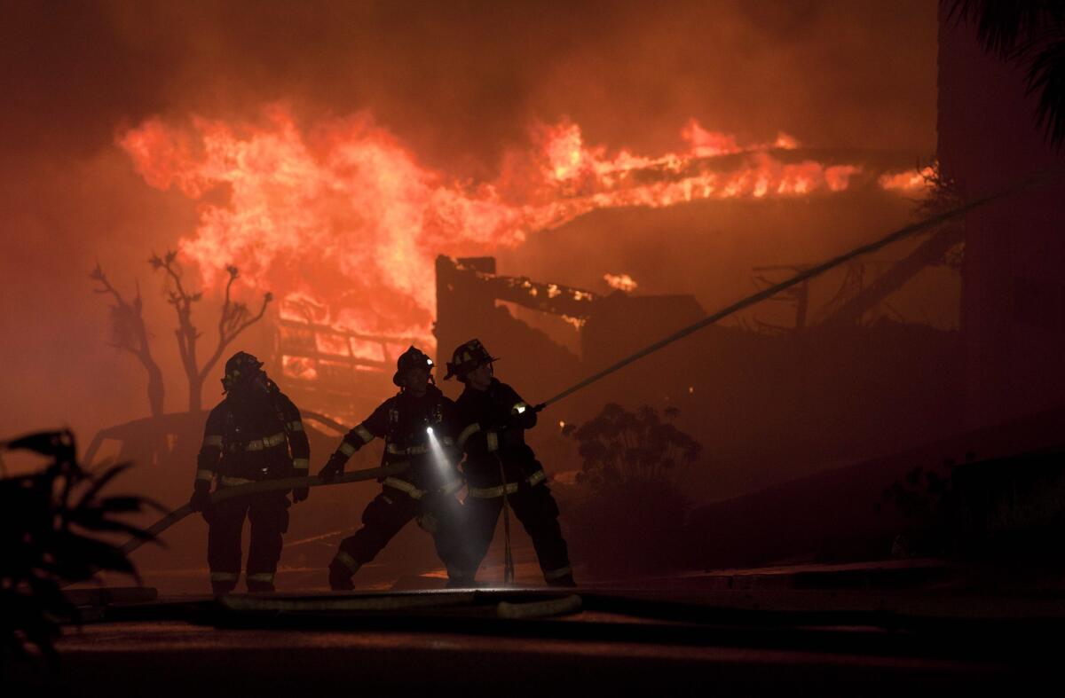 Firefighters battle house fires after a massive explosion rocked a neighborhood in San Bruno in 2010.