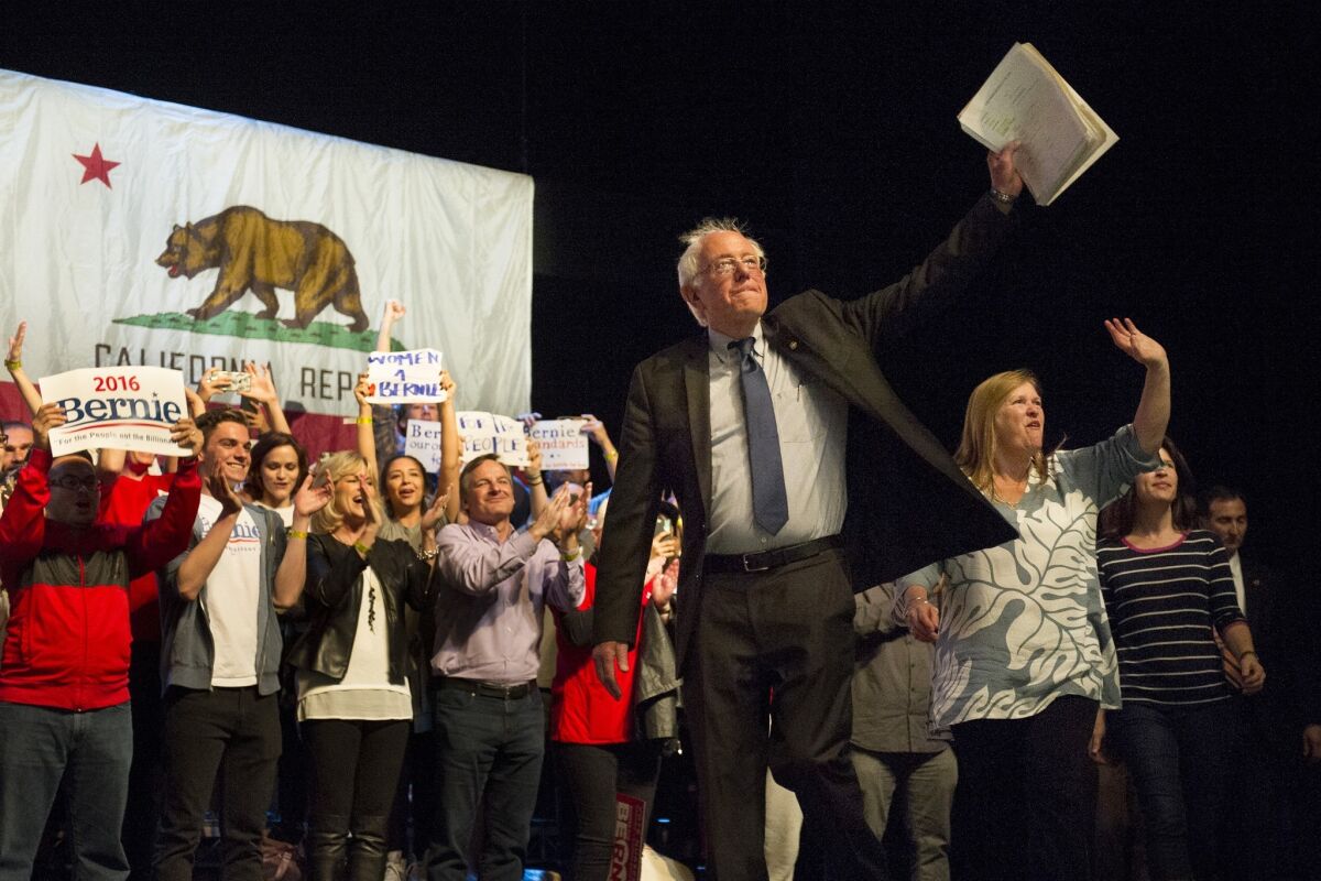 Democratic presidential candidate, Sen. Bernie Sanders of Vermont walks onstage with his wife, Jane O'Meara Sanders, at a rally March 23 in Los Angeles.
