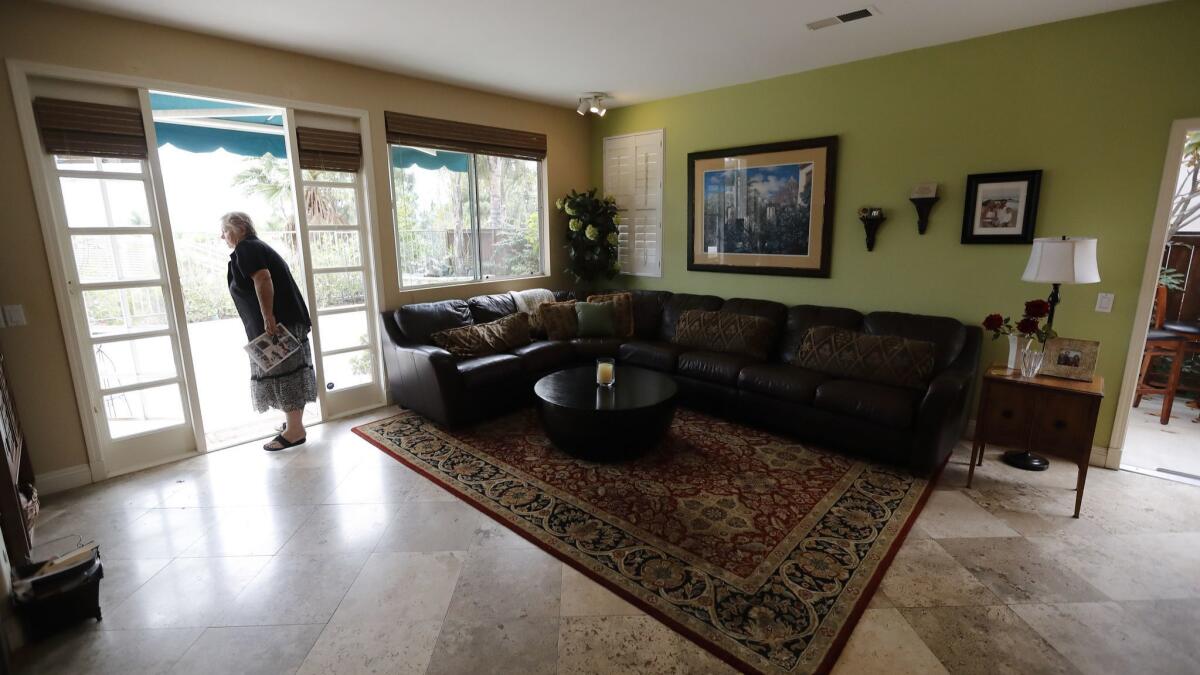 Vicky Campbell looks around a home for sale in her former neighborhood during an open house in Chula Vista, Calif. on Oct. 3, 2018.