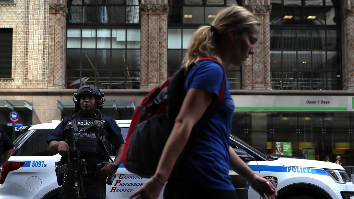 A New York City police officer stands guard outside Grand Central Terminal.