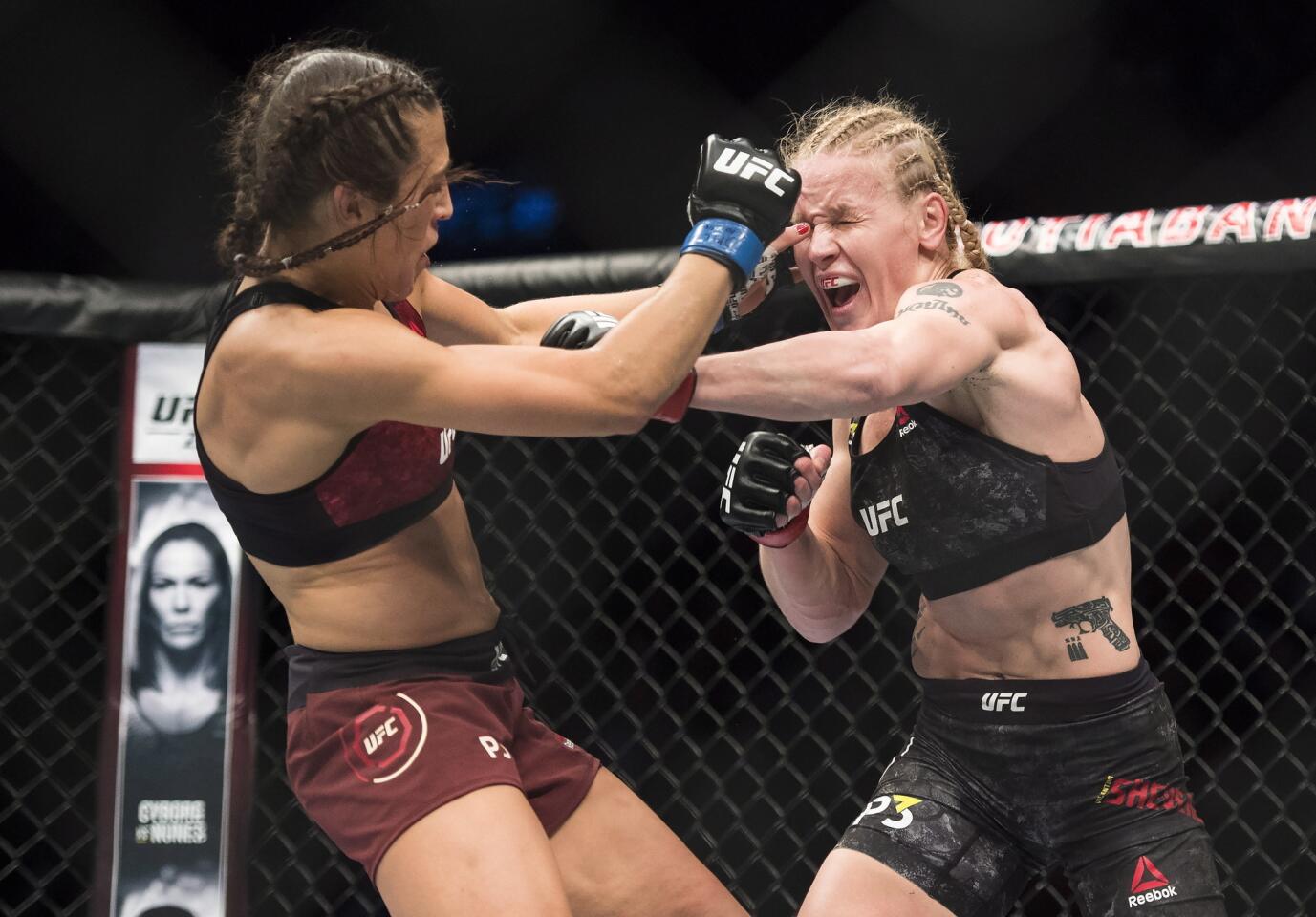 Valentina Shevchenko, right, fights Joanna Jedrzejczyk during a women's flyweight mixed martial arts bout at UFC 231 in Toronto on Saturday, Dec. 8, 2018. (Nathan Denette/The Canadian Press via AP)