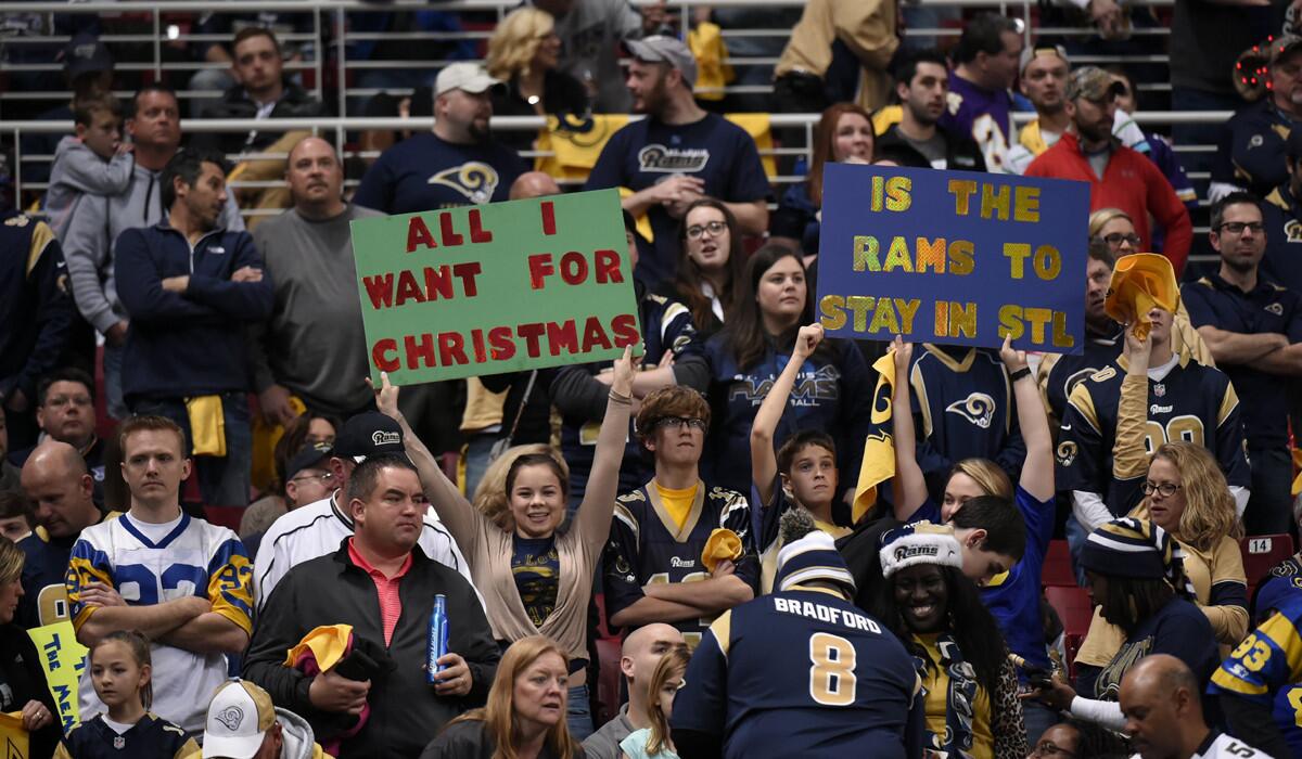 St. Louis Rams fans hold up signs in the stands during the second quarter between the Rams and the Tampa Bay Buccaneers on Dec. 17.