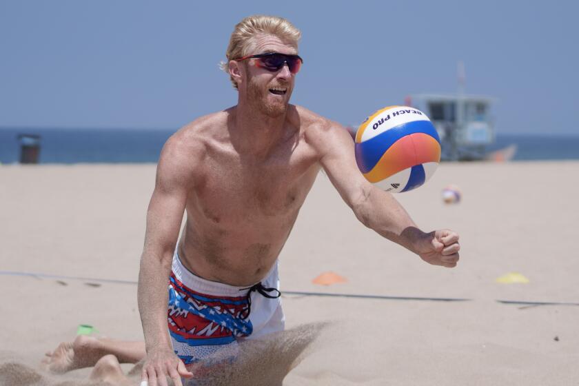 HERMOSA BEACH CA JUNE18, 2024 - Chase Budinger and beach volleyball partner Miles Evans.