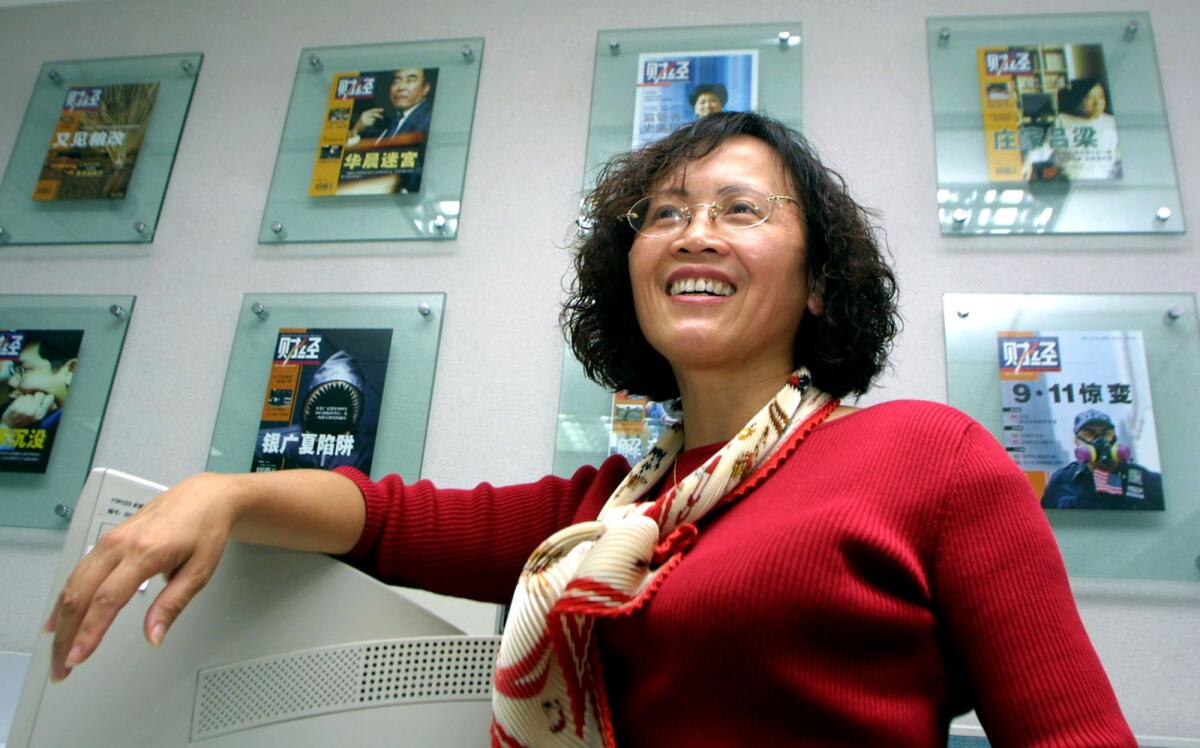 Hu Shuli, managing editor of the current affairs magazine Caixin, poses in her Beijing office in 2002. The magazine recently ran an article about an online post it said China’s Internet watchdog had ordered removed.