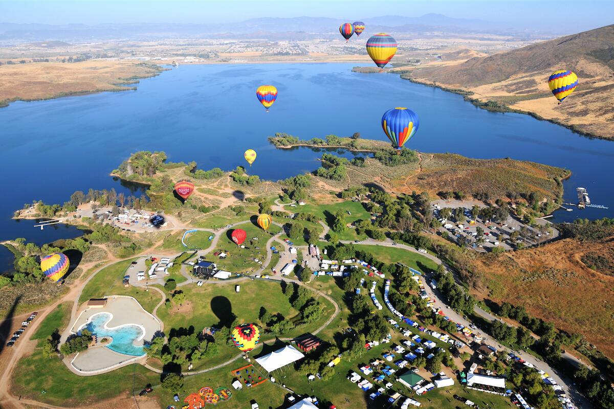 Aerial view of hot air balloons over land and water in Temecula