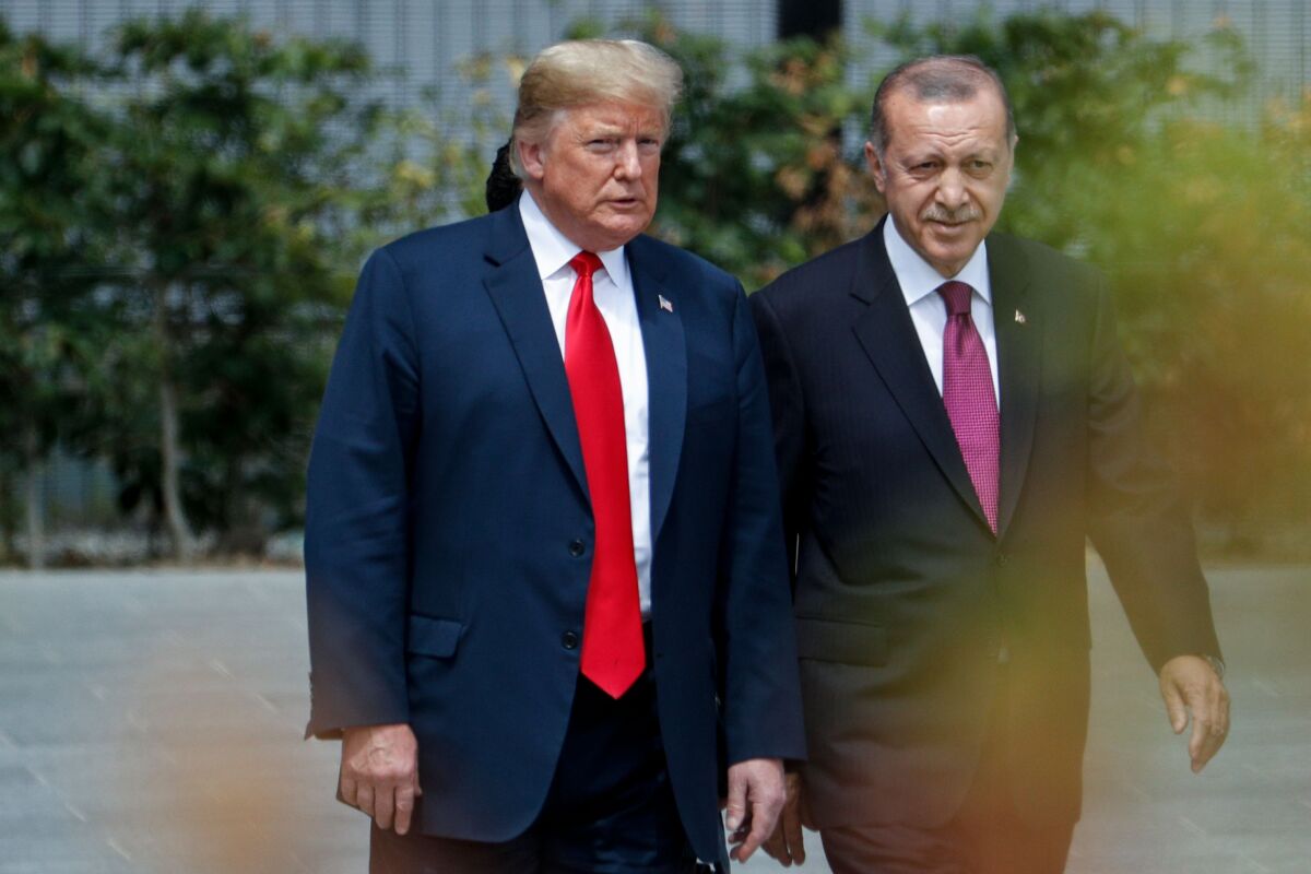 President Trump speaks to Turkey's President Recep Tayyip Erdogan during the opening ceremony of the NATO summit in Brussels on July 11, 2018.