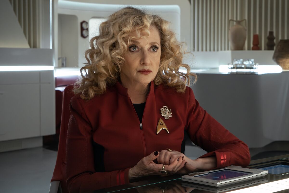 A woman in a Star Trek uniform sits at her station