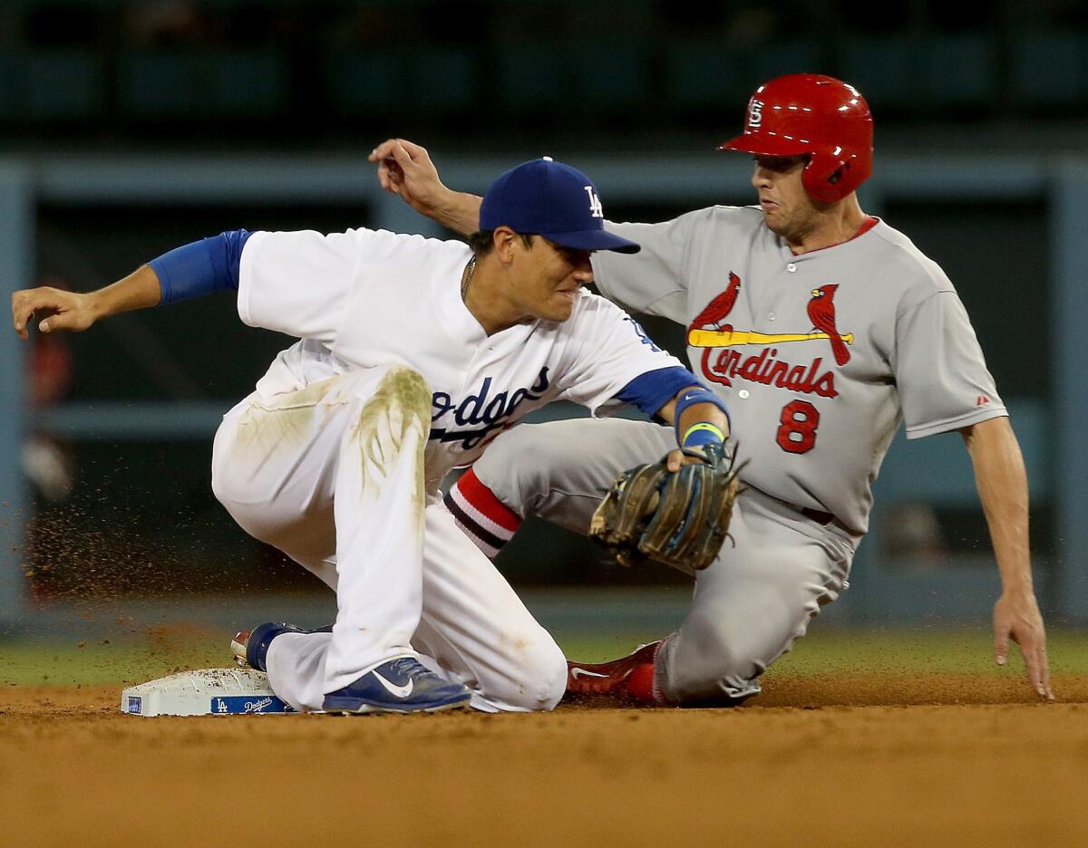 Dodgers shortstop Miguel Rojas catches St. Louis' Peter Bourjos trying to steal in the ninth inning.