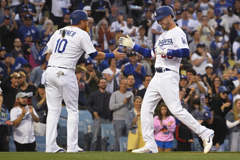 Justin Turner, left, greets Dodgers teammate Cody Bellinger after Bellinger hits a two-run, second-inning homer June 3, 2022.