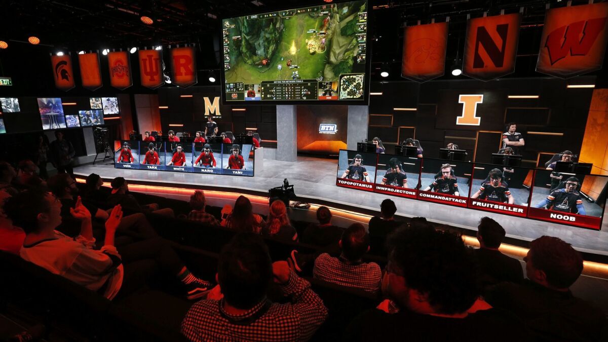 Fans watch a match between the University of Maryland, left, and the University of Illinois in the Big Ten Network "League of Legends" championship in the Battle Theater at North American League Championship Arena at Riot Games in Los Angeles in 2017.