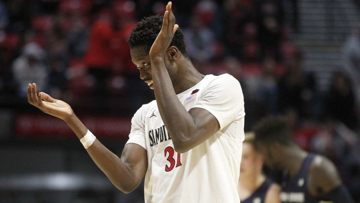 SDSU center Nathan Mensah, shown here in a 2019 game against Utah State, is moving closer to receiving medical clearance to play again.