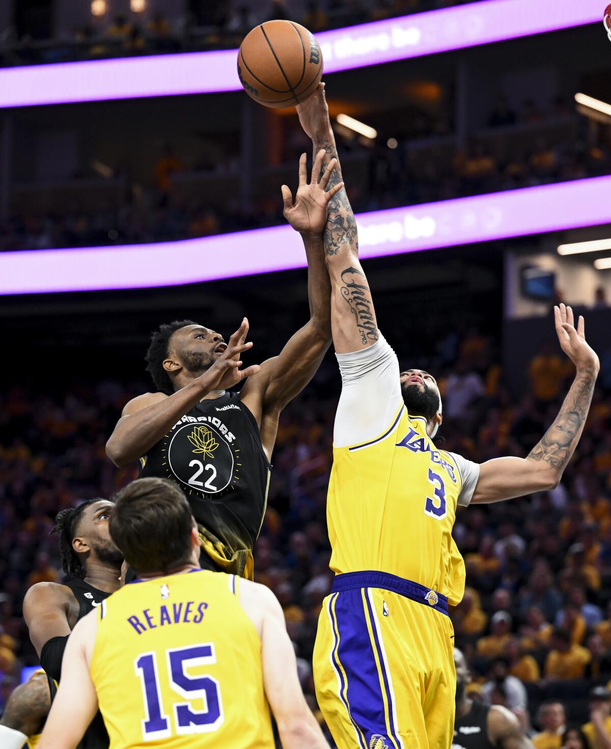 Lakers forward Anthony Davis reaches overhead to block a shot by Warriors forward Andrew Wiggins in Game 1.