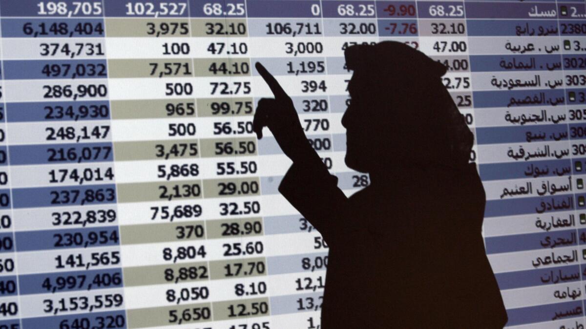 The shadow of a Saudi trader is seen on a stock market monitor in Riyadh, Saudi Arabia, on Oct. 7, 2008. The Saudi stock market fell sharply Sunday after President Trump threatened "severe punishment" over the disappearance of Washington Post contributor Jamal Khashoggi.