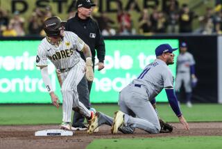 San Diego, CA, Tuesday, October 8, 2024 - Los Angeles Dodgers shortstop Miguel Rojas (11) picks himself up after flipping over San Diego Padres outfielder Jackson Merrill (3) on a botched double play attempt in game three of the National League Diviisional Series at Petco Park. (Robert Gauthier/Los Angeles Times)