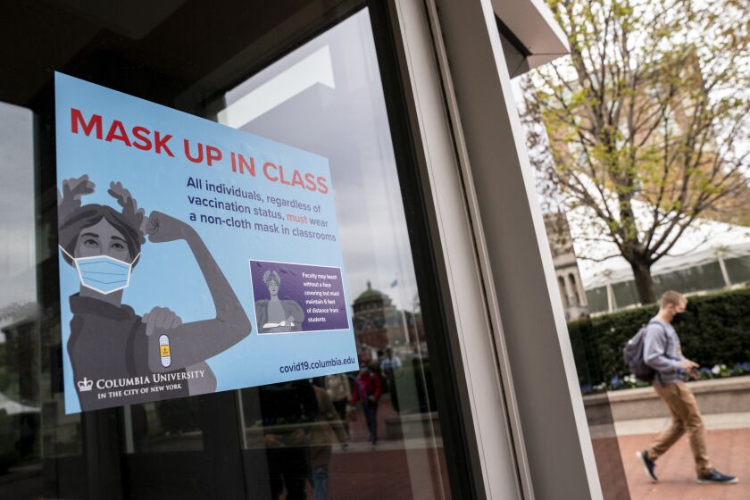 Signs indicating that protective face masks must be worn in classrooms are displayed outside lecture halls at Columbia University, Thursday, April 21, 2022, in the Manhattan borough of New York. (AP Photo/John Minchillo)