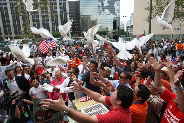 May Day march organizers release more than 200 doves to mark the beginning of the procession down Broadway.