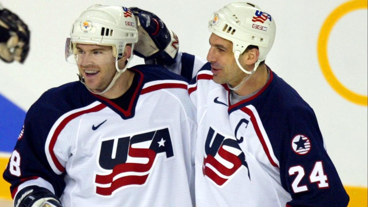 Scott Young, left, and Chris Chelios of the U.S. celebtate Young's third-period goal against Belarus at the 2002 Salt Lake City Olympics.