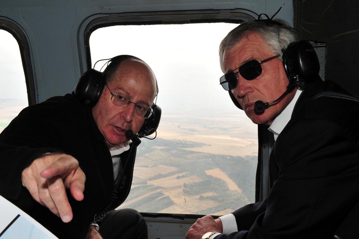 Israeli Minister of Defense Moshe Yaalon, left, takes Defense Secretary Chuck Hagel on a helicopter tour of the Golan Heights.