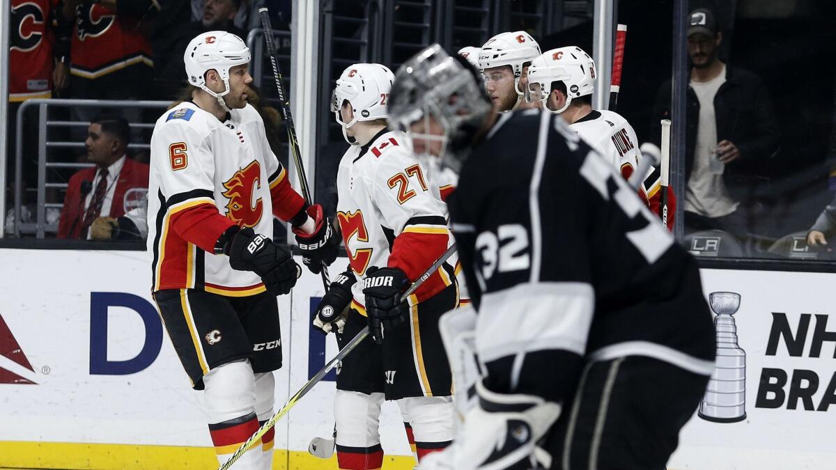 Calgary Flames players celebrate their goal against the Kings during the third period.