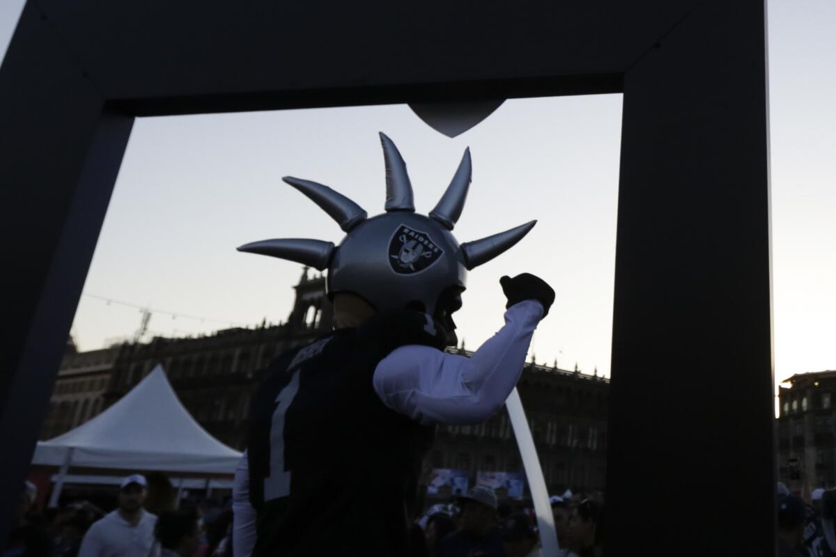 The Oakland Raiders mascot poses for pictures as fans interact during NFL football's Fan Fest at Zocalo Square 