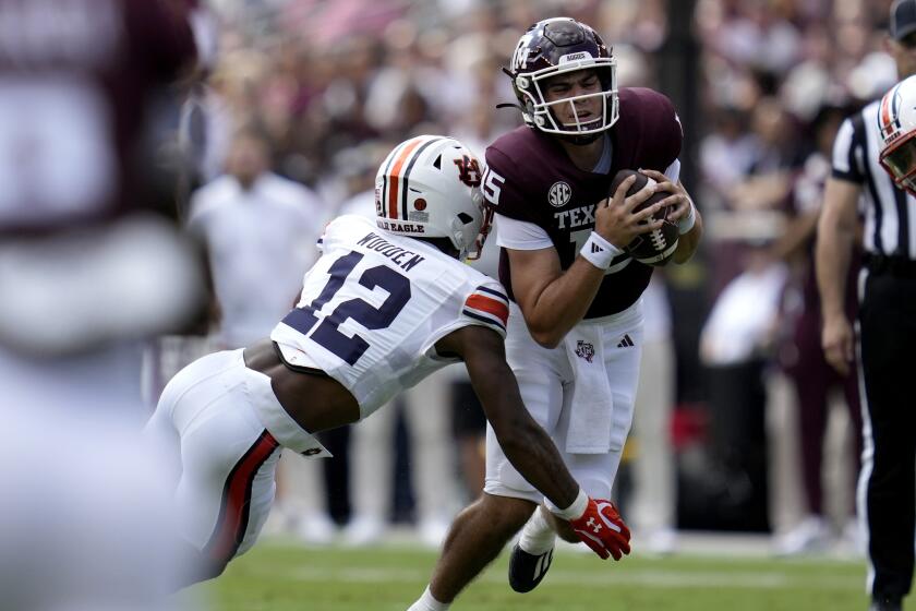 Auburn safety Caleb Wooden (12) sacks Texas A&M quarterback Conner Weigman (15) for a loss during the first quarter of an NCAA college football game Saturday, Sept. 23, 2023, in College Station, Texas. (AP Photo/Sam Craft)