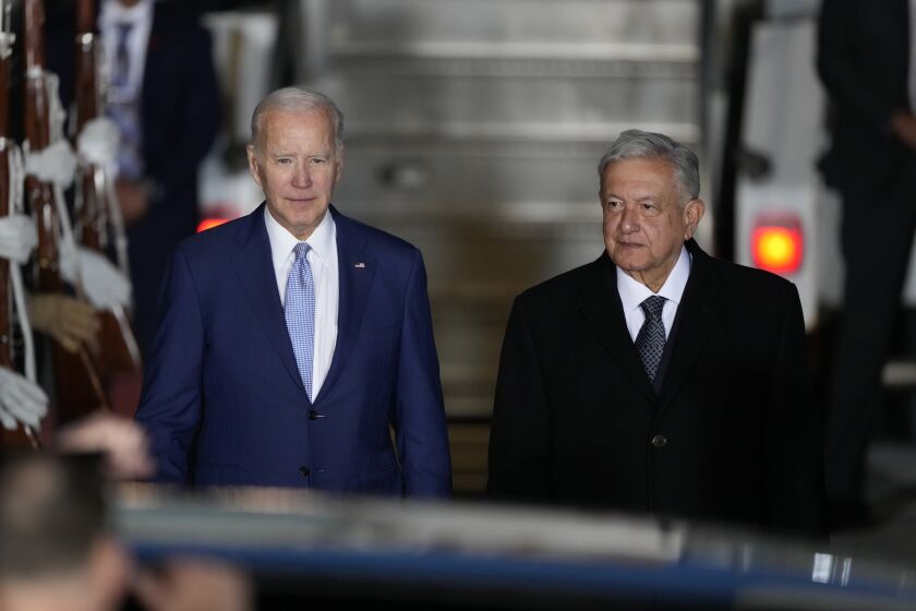 U.S. President Joe Biden walks with Mexican President Andres Manuel Lopez Obrador, at his arrival to the Felipe Angeles international airport in Zumpango, Mexico, Sunday, Jan. 8, 2023. (AP Photo/Fernando Llano)