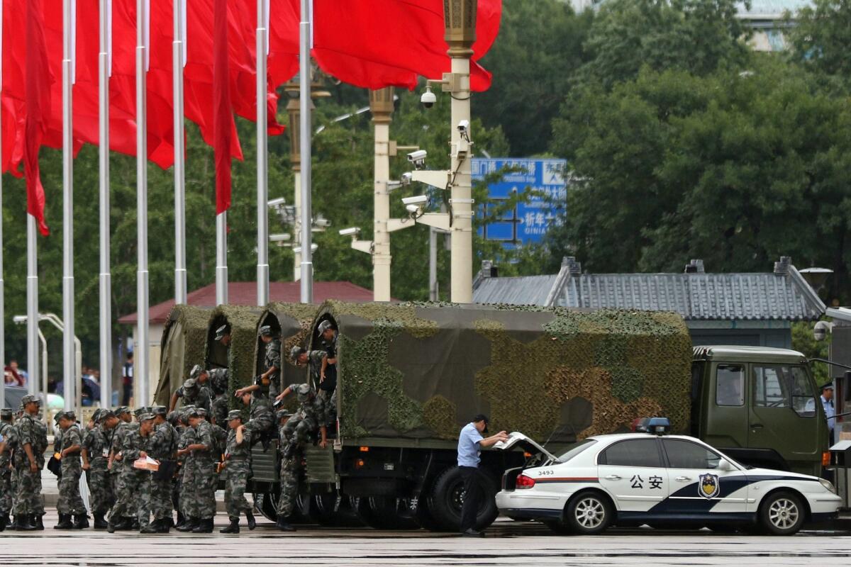 Chinese soldiers disembark from trucks Tiananmen Square in Beijing on Sept. 1 amid preparations for a major military parade.