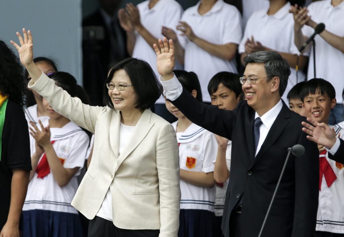 Taiwan President Tsai Ing-wen and Vice President Chen Chien-je wave to supporters during her inauguration in Taipei on May 20.